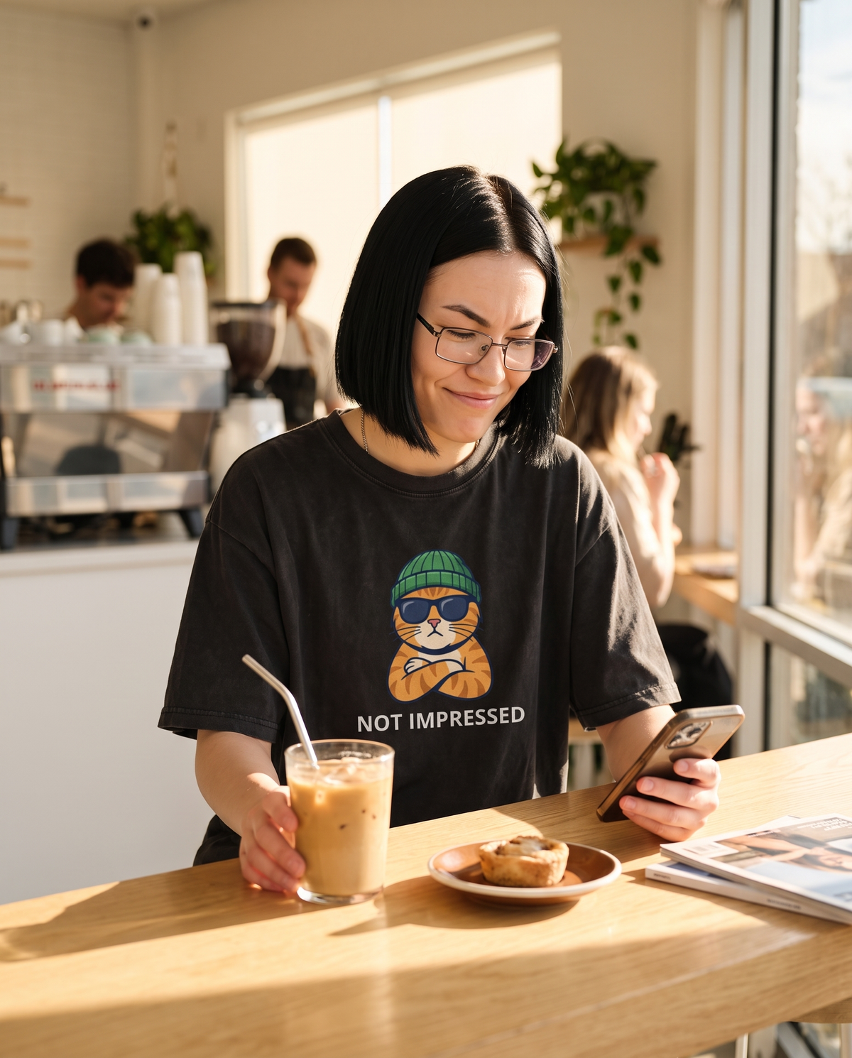 Not Impressed oversized tee worn in a coffee shop